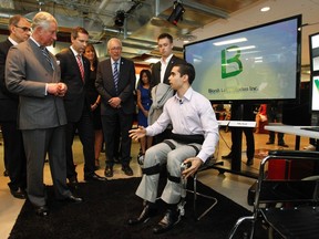 Britain's Prince Charles, left, views a rehabilitation device at a digital innovation zone at Ryerson University on May 22, 2012.(Mark Blinch/Reuters)