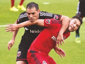 TFC's Jonathan Osorio fights for the ball with D.C. United' s Fabian Espindola during Saturday's game. (USA TODAY SPORTS)