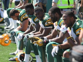 Members of the Edmonton Eskimos sit on the sidelines in Fort McMurray Alta. on Saturday June 27, 2015. Robert Murray/Fort McMurray Today/Postmedia Network