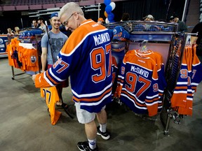 Dane McCoy trys on a Connor McDavid jersey during the Edmonton Oilers Locker Room Sale at Rexall Place, in Edmonton Alta. on Saturday June 27, 2015. David Bloom/Edmonton Sun/Postmedia Network