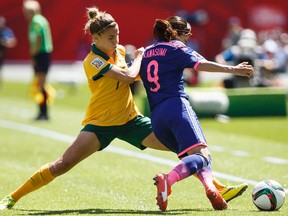 Australia's Steph Catley pushes Japan's Nahomi Kawasumi during Saturday's World Cup quarterfinal at Commonwealth Stadium (Ian Kucerak, Edmonton Sun).