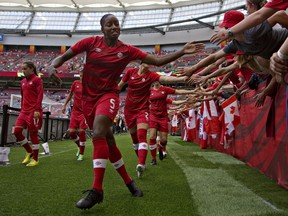 Canada defender Robyn Gayle greets fans prior to their quarterfinal football match against England during the 2015 FIFA Women's World Cup at BC Place Stadium in Vancouver, British Columbia on June 27, 2015.      AFP PHOTO/ANDY CLARK