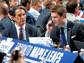Leafs prez Brendan Shanahan looks on while assistant GM Kyle Dubas works the phones at the team’s draft table. (AFP)