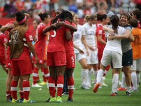 Canadian defender Kadeisha Buchanan (3) hugs teammates after losing to England in the quarterfinals of the FIFA 2015 Women's World Cup at BC Place Stadium. England won 2-1. (Matt Kryger/USA TODAY Sports)