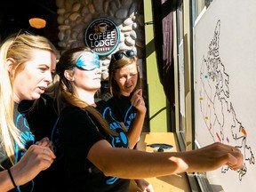 Natural Disasters team members try to pin place names on a map of Canada, while blindfolded, during a Race to Erase pit stop challenge in 2014. This year marks the 10th anniversary of the fundraiser for local charities. (Handout)