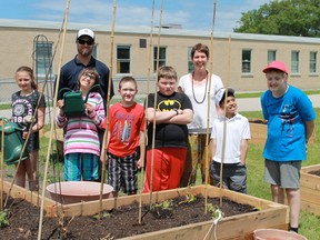 Alexander Mackenzie Secondary School teacher Ryan Hanly and Errol Road Public School teacher Sheila Ward stand with a group of green-thumbed students at Errol Road's new outdoor classroom. Alexander Mackenzie construction students helped create the new facility. (Carl Hnatyshyn/ Postmedia Network)