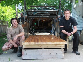 Jeff Wickens, right, who runs Hi-Way Bowl on London Line, and newly-hired mechanic Sean Burr are setting up an outdoor bowling lane in Wickens' driveway at 16 Alfred St. in Point Edward to raise funds for the Canadian Cancer Society. The lane will be open to the public on Canada Day in an informal setting, with donations for cancer accepted, followed by a tournament at 5 p.m. (Terry Bridge/Sarnia Observer/Postmedia Network)