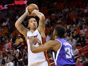 Miami Heat forward Michael Beasley (30) shoots over Sacramento Kings forward Jason Thompson (34) during the second half at American Airlines Arena. The Heat won in overtime 114-109. (Steve Mitchell-USA TODAY Sports)