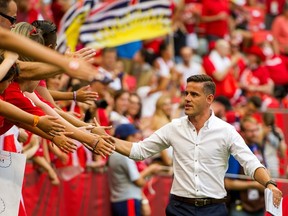 John Herdman high fives fans on the way to the team room prior to the start of the FIFA Women's World Cup Canada 2015 quarterfinal match between England and Canada June, 27, 2015 at BC Place Stadium in Vancouver, British Columbia, Canada. Rich Lam/Getty Images/AFP