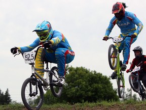 Zaithyel Soekander (blue helmet) and teammate Feddison Akeem Flanders (orange helmet) from Aruba compete at the Limestone City Nationals in Kingston on Saturday. (Steph Crosier/The Whig-Standard)