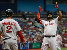 Boston Red Sox designated hitter David Ortiz (right) celebrates with teammate Xander Bogaerts after hitting a two-run home run during the fourth inning of their team's won over the Tampa Bay Rays on June 28, 2015, at Tropicana Field in St. Petersburg, Fla. (KIM KLEMENT/USA TODAY Sports)