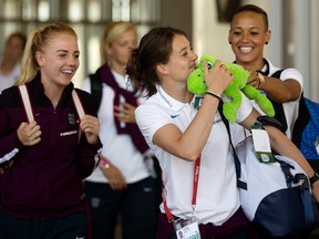 (left to right) Alex Greenwood, Jade Moore and Lianne Sanderson joke around with a stuffed toy as members of the England Women's National Team arrive at the Edmonton Shell Aerocentre, in Edmonton Alta. on Sunday June 28, 2015. England will play Japan in Edmonton July 1 during the FIFA Women's World Cup Canada 2015. David Bloom/Edmonton Sun/Postmedia Network