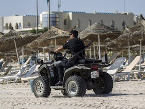 A police officer patrols the beach near the Imperial Marhaba resort, which was attacked by a gunman in Sousse, Tunisia, June 29, 2015. The gunman disguised as a tourist opened fire at the Tunisian hotel last Friday with a rifle he had hidden in an umbrella, killing 39 people including Britons, Germans and Belgians as they lounged at the beach in an attack claimed by Islamic State.  REUTERS/Zohra Bensemra