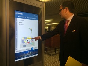 Deputy Mayor Denzil Minnan-Wong unveils two new digital signs at Toronto City Hall on Monday, June 29, 2015. (Don Peat/Toronto Sun)