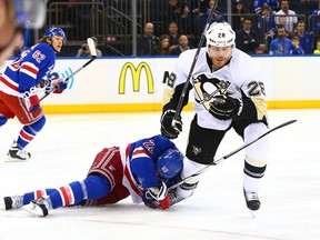 Pittsburgh Penguins defenceman Ian Cole (28) knocks New York Rangers defenceman Dan Boyle (22) to the ice during game 2 the 2015 NHL Stanley Cup Playoffs Round 1 at Madison Square Garden. Andy Marlin-USA TODAY Sports