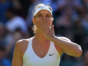 Russia's Maria Sharapova reacts after winning her women's singles first round match against Britain's Johanna Kontaduring on day one of the 2015 Wimbledon Championships. (AFP PHOTO/GLYN KIRK)