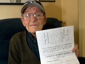 Wally Stanowski holds his old contract in his Etobicoke home Oct 11, 2012. (MICHAEL PEAKE/TORONTO SUN)