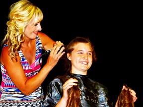 Graduating MDHS Grade 8 student Elysha Vorstenbosch had her head shaved by Gerdina Goodyer in the school's gymnasium June 25 after raising $1,718.60 for Cystic Fibrosis Canada, overshooting her goal of $1,500. GALEN SIMMONS/MITCHELL ADVOCATE