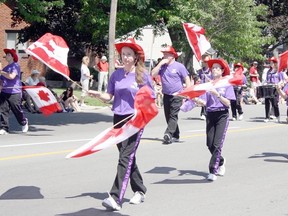 Members of the St. Clair Colts Drumline spin their flags to entertain parade-goers in this file photo of the Sarnia Canada Day parade. This year's parade is scheduled to leave the corner of Lakeshore and Colborne roads Wednesday at 11:30 a.m. for the celebrations in Canatara Park. (File photo)