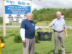 JESSICA LAWS/ FOR THE INTELLIGENCER
Bob Clute, executive director for Habitat for Humanity Prince Edward-Hastings, and Rick Clow, general manager of Quinte Waste Solutions, prepare for the bottle drive on Saturday, July 11 in Belleville. One hundred per cent of deposit-returns will go toward the building of two homes on Golfdale Road.