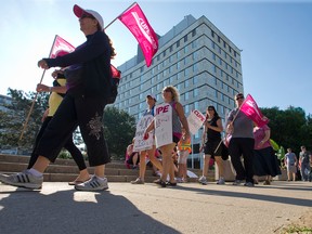 CUPE Local 101 members picket outside of city hall on Wellington Street as the 750 inside city workers. (CRAIG GLOVER, The London Free Press)