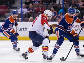 Justin Schultz and Florida Panthers forward Scottie Upshall battle for the puck during a game at Rexall Place in January. (Ian Kucerak, Edmonton Sun)