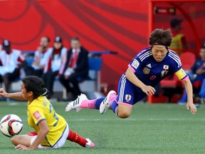 Japan's Aya Miyama gets airborne during a round-robin game in Winnipeg (Bruce Fedyck, USA Today Sports).