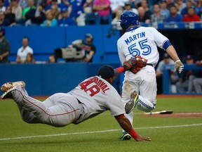 Blue Jays baserunner Russell Martin is caught by Red Sox third baseman Pablo Sandoval during second inning MLB action in Toronto on Monday, June 29, 2015. (Jack Boland/Postmedia Network)
