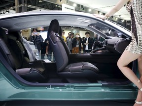 Visitors takes photographs of a Kia Motor's concept car Novo as a model poses at the Seoul Motor Show 2015 in Goyang April 3, 2015. (REUTERS)
