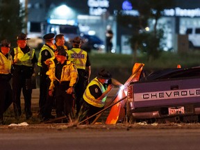Edmonton Police Service officers investigate a fatal crash involving a Chevrolet pickup truck on southbound Calgary Trail, south of Ellerslie Road in Edmonton on Monday, June 29, 2015. (Ian Kucerak/Edmonton Sun/Postmedia Network)