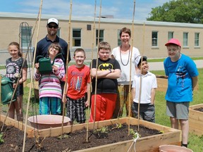 Alexander Mackenzie Secondary School teacher Ryan Hanly and Errol Road Public School teacher Sheila Ward stand with a group of greenthumbed students at Errol Road's new outdoor classroom on June 23. Alexander Mackenzie construction students helped create the new facility. 
CARL HNATYSHYN/SARNIA THIS WEEK