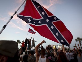 Participants in the "Ride for Pride" event stand on the back of their pickup truck as they speak to an assembled crowd during the impromptu event to show their support the Confederate flag in Brandon, Hillsborough County, June 26, 2015. Several hundred people took part in the event.    REUTERS/Carlo Allegri