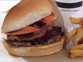 The Burger’s Priest ultimate Canada Burger includes one beef patty topped with a Nova Scotia lobster claw, Ontario bacon and of course, Quebec maple syrup. (Postmedia Network)