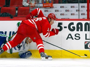 Carolina Hurricanes forward Alexander Semin (28) checks Vancouver Canucks forward Derek Dorsett into the boards during NHL play at PNC Arena. (James Guillory/USA TODAY Sports)