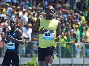 Usain Bolt (right) of Jamaica wins the men’s 200-metres during the Adidas Grand Prix IAAF Diamond League track and field meet June 13, 2015 in New York. (AFP PHOTO/DON EMMERT)