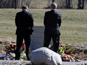 Lufthansa Chief Executive Carsten Spohr (L) and Germanwings Managing Director Thomas Winkelmann carry flowers as they pay their respects at the memorial for the victims of the air disaster in the village of Le Vernet, near the crash site of the Germanwings Airbus A320 in French Alps April 1, 2015.    REUTERS/Jean-Paul Pelissier