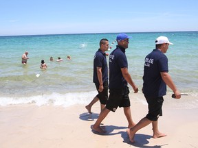 Police officers patrol on the beach near the Imperial Marhaba Hotel in Sousse,, Tunisa, four days after Friday's terrorist attack, Tuesday, June 30, 2015. One of Tunisia's top security officials says the gunman who killed 38 tourists in a beach attack was trained in neighbouring Libya at the same time as the attackers who targeted the Bardo Museum in March. AP Photo/Abdeljalil Bounhar