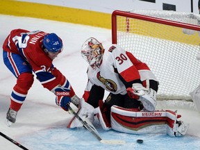 Montreal Canadiens winger Brian Flynn (32) slips the puck past Ottawa Senators goalie Andrew Hammond during Game 1 of the NHL’s first-round playoff series Wednesday, April 15, 2015 in Montreal. (THE CANADIAN PRESS/Ryan Remiorz)