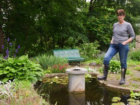 Carol Lamont, Eldon House's director of adminstration, looks over the pond where a missing cast iron statue was stolen Sunday night or early Monday in London. Mike Hensen/The London Free Press/Postmedia Network