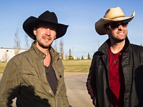 Country singers Paul Brandt, left, and Dean Brody, right, chat after exiting a helicopter near Factor Forms in Edmonton, Alta. (Codie McLachlan/Postmedia Network)