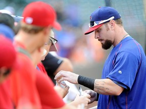 Josh Hamilton of the Texas Rangers signs autographs before the game against the Baltimore Orioles at Oriole Park at Camden Yards on June 29, 2015 in Baltimore. (Greg Fiume/Getty Images/AFP)