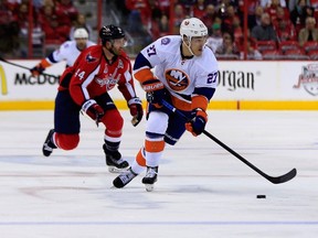 Anders Lee of the New York Islanders skates with the puck against the Washington Capitals during Game 5 of the Eastern Conference quarterfinals at Verizon Center on April 23, 2015 in Washington. (Rob Carr/Getty Images/AFP)