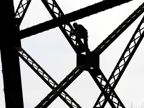 Firefighter Kyle Wilkinson and members of the Edmonton Fire Department's technical rescue team train under the High Level Bridge, in Edmonton Alta. on Tuesday June 30, 2015. David Bloom/Edmonton Sun/Postmedia Network