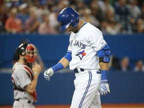 Blue Jays' Jose Bautista returns to the plate to bat during Tuesday night's game against the Boston Red Sox in Toronto. (AFP/PHOTO)