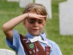 Elli Jones, a Girl Scouts Brownie, salutes in Los Angeles, California, May 25, 2013. 
REUTERS/Jonathan Alcorn