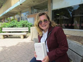 Beverly Anger holds a copy of the writings of Plato outside the Sarnia Public Library on Friday June 26, 2015 in Sarnia, Ont., where she is offering a free summer seminar for high school students in July titled, An Introduction to the Platonic Dialogues.  Paul Morden/Sarnia Observer/Postmedia Network