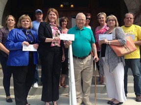 Mayor Heather Jackson, second left, presents city grant cheques totaling $127,500 to six community organizations Monday morning. The Talbot Teen Centre, YMCA of St. Thomas-Elgin and Iron Horse Festival were among the largest grant recipients this year.