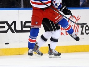 Matt Hunwick #44 of the New York Rangers and Trevor Lewis #22 of the Los Angeles Kings collide on March 24, 2015 at Madison Square Garden in New York City. (AFP)