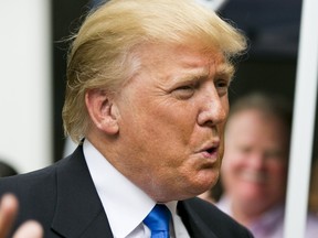 Businessman and Republican presidential candidate Donald Trump reacts to supporters during a back-yard reception in Bedford, New Hampshire, June 30, 2015.  REUTERS/Dominick Reuter