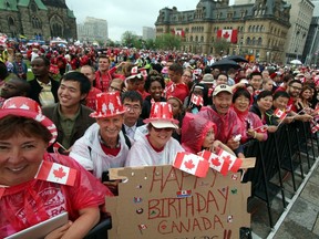Thousands of people braved rain showers to celebrate Canada Day on Parliament Hill in Ottawa, Wednesday, July 1, 2015. THE CANADIAN PRESS/Fred Chartrand
